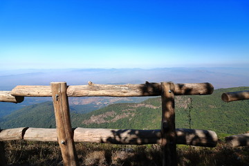 Wooden fence of Kew Mae Pan nature trail with mountain scenery background at Doi Inthanon , Chaing Mai , Thailand
