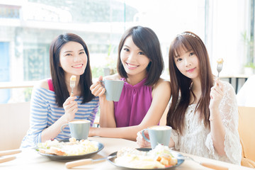happy woman friends in restaurant