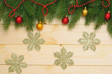 Fototapeta na wymiar Christmas background. Top view with copy space. fir tree with cone on light wooden background