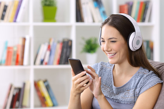 Female listening music on line at home
