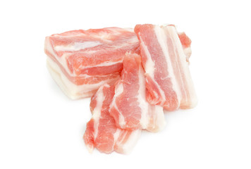 Partly sliced uncooked pork belly on a white background