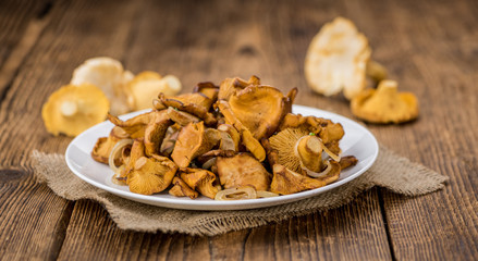 Fresh made Fried Chanterelles on a rustic background