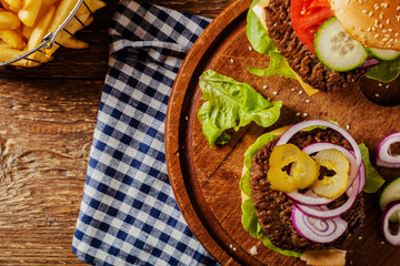 Homemade, beef hamburger with cheese and vegetables.