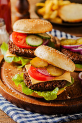 Homemade, beef hamburger with cheese and vegetables.