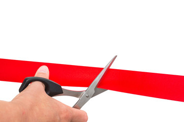 Hand with scissors cutting red ribbon - opening ceremony