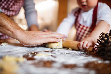 Young family making cookies at home.