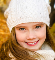 Autumn portrait of adorable little girl in hat