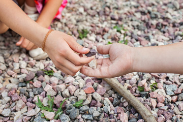 Little girl giving stones