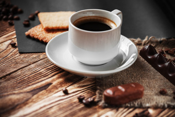 Coffee cup and cookie on wood