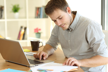 Freelance worker working at home reading documents