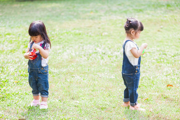 Cute Kids 2-3 Year Old Playing Bubble in the garden