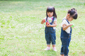 Fototapeta premium Cute Kids 2-3 Year Old Playing Bubble in the garden