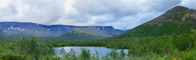 Clean lake at the foot of the Khibiny mountains, Kola Peninsula, Russia.