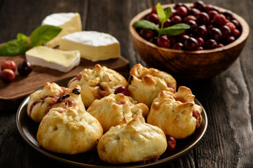 Puff pastry pies with camembert cheese and cranberries. 