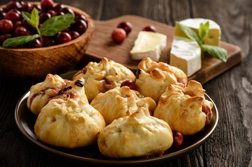 Puff pastry pies with camembert cheese and cranberries. 
