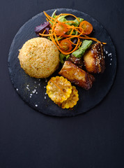 Barbecue pork ribs with rice, salad and corn, top view