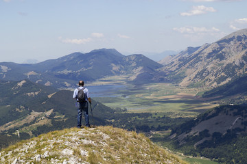 Fototapeta na wymiar hiker in mountain landscape valley and lake