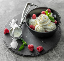 ice cream with raspberries served in black piala