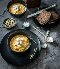pumpkin soup in black plates 