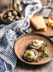 Stuffed mushrooms with quail eggs and parmesan cheese.