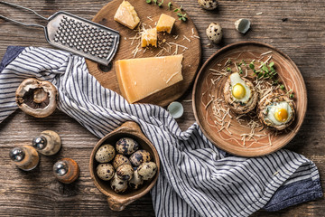 Stuffed mushrooms with quail eggs and parmesan cheese, top view.