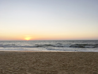 watching the sunset on the horizon at the beach 