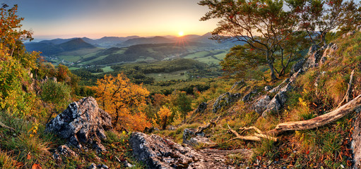 Panorama of sunset in a Carpathian mountain valley with wonderful gold light on a hills