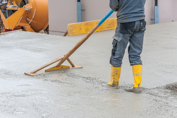 leveling fresh concrete on worksite © Redfox1980