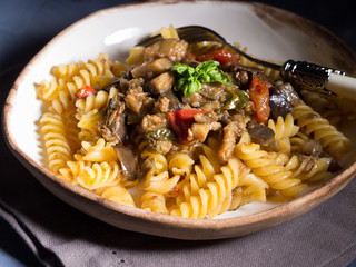 Fusilli pasta with eggplant and tomato sauce. Traditional italian dish