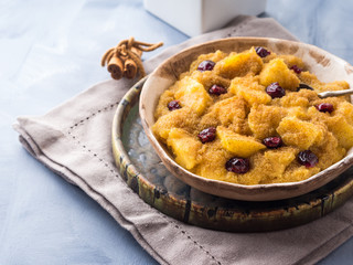 Amaranth porridge with apples, cinnamon, turmeric and dried fruit. Gluten free breakfast meal
