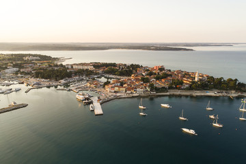 aerial drone view of sunrise over novigrad in summer