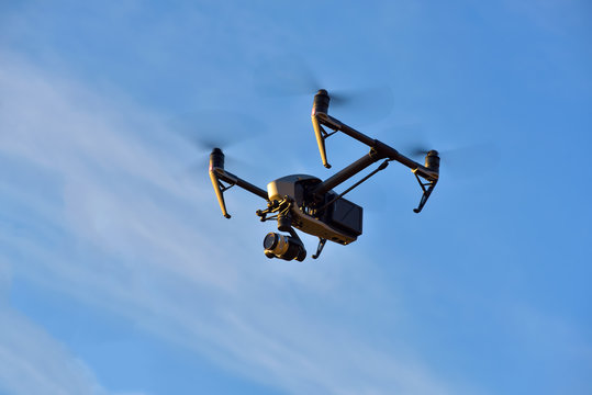 Flying big drone on blue sky background