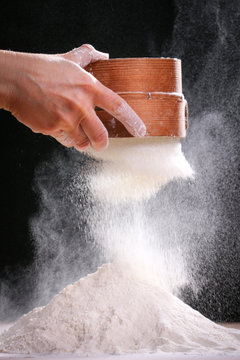 Making dough by female hands at home in kitchen