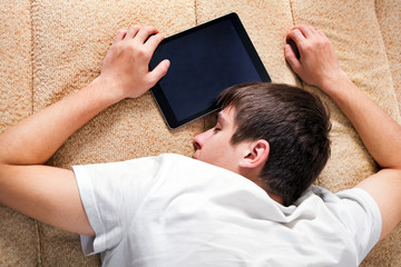 Young Man sleep with Tablet Computer