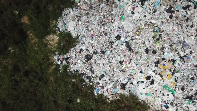 Environmental problem - plastic garbage pollution. Rubbish dump landfill ruins forest environment. 