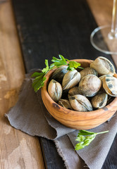 Wooden Bowl full of clams live, ready to be cooked.