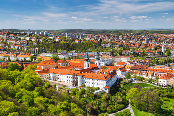 Fototapeta na wymiar View of Strahov Monastery in Prague, Czech Republice. Red roofs and parks