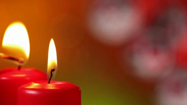 Lighting the christmas candles and refocusing to beautiful xmas decorations - against blurry blinking lights background