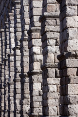 Stone pillars of arches on a roman aqueduct in Segovia, Spain