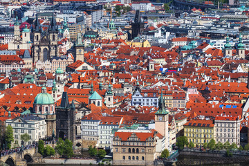Fototapeta na wymiar erial view of old Red Tiles roofs in the city Prague, Czech Republic, Europe. Beautiful day with blue sky with clouds in the town.
