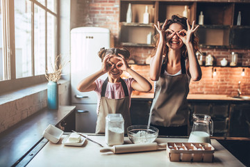 Mom with daughter on kitchen.