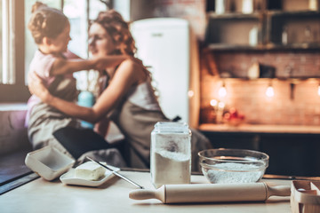 Mom with daughter on kitchen.