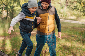 Fototapeta premium father and son walking in forest