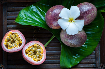 Passion fruit whole and slise on a natural background. Tropical fruits. The Fruit of Passion. Maracuya
