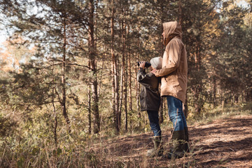 father and son with binoculars