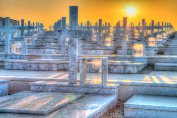 The Art of alternative positive and colorful view to the sunset of death and marble crosses at the cemetery