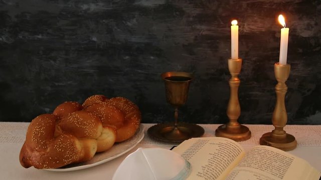 shabbat footage. challah bread, shabbat wine and candles on the table