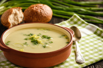 Leek cream soup on black background.