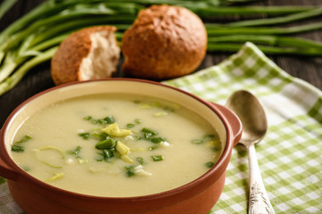 Leek cream soup on black background.