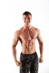 Fototapeta premium Handsome young sportsman standing isolated